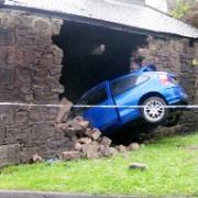 DEMOLISHED: The MG-ZR embedded in the barn after the driver crashed through the outer wall