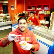 UNITED: Manager Muddasir Ilyas, (front) and co-owner Asam Zaman in the Shazam sports cafe they have opened in Colne Road, Burnley with two other friends