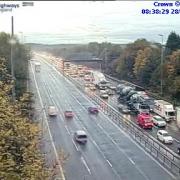 Congestion building following crash on busy motorway during rush hour