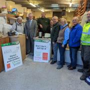 Gift 92 and Selnet staff standing with Cllr Michael Green at Gift 92's warehouse.