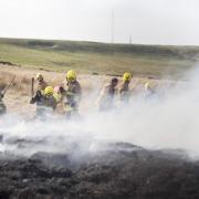 smoke screen Firefighters dampen down the flames at Belmont
