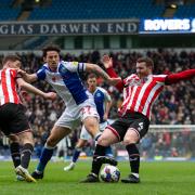 Lewis Travis vies for possession with Sheffield United's John Fleck and Chris Basham