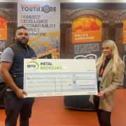 Ben Smithson awards a donation to Blackburn and Darwen Youth Zone's Melanie Thomas