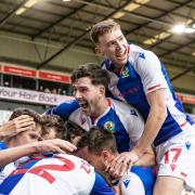 Sam Szmodics is mobbed by his team mates after scoring his side’s second goal