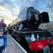 Edward Almond, 3, is following in his great-granddad's footsteps, waving in the Flying Scotsman at Ramsbottom Station
