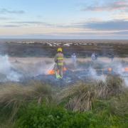 Firefighters tackling a blaze, caused by a disposable barbecue, at Wind Sports Centre in Fylde