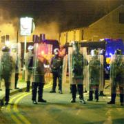 FRIGHTENING TIMES Riot police line the streets of Burnley.
