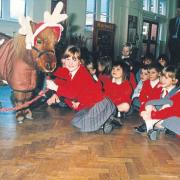 St Charles Primary School pupils with a miniature pony posing as a reindeer