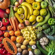 Colorful vegetables and fruits vegan food in rainbow colors arrangement full frame.