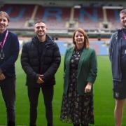 Max McCann (second left) has collaborated with Burnley FC in the Community Foodbank