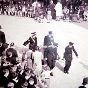A fainting victim is taken away by stretcher in October 1965