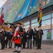 Town Crier welcomes the banner on Broadway
