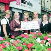 PENNY WISE Marsden staff hand over a cheque for £13,584. From left: Trish Rockcliffe, Elaine Brown, Kaye Bartle, from the hospice, Judith Blackledte, Christine Cope, Rebecca Bolton and Sarah Hasty