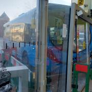 The bus was wedged into the glass doorways at the bus station