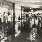 Shoppers paddling through the floodwater at Blackburn shopping precinct in 1987