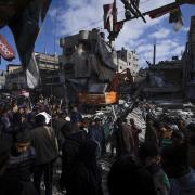 Palestinians search for bodies and survivors in the rubble of a residential building destroyed in an Israeli airstrike in Rafah, Gaza Strip, Monday, March 4, 2024. (AP Photo/Fatima Shbair).
