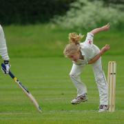 A stock image of children playing cricket