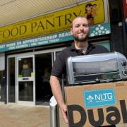 Eddy O Brien, chair of Hyndburn Food Pantry with the donation of a new toaster from NLTG