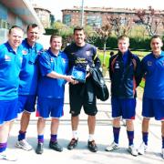 Nigel Dixon hands over a friendship plaque to a Barcelona junior coach