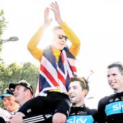 Bradley Wiggins celebrates his victory with team mates on Sunday