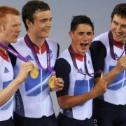 Ed Clancy (left), Geraint Thomas (right), Steven Burke (second left) and Peter Kennaugh celebrate with their Gold medals
