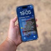 A general view of a phone warning against lighting anything that could spark a wildfire, including barbecues, campfires, and fireworks with parched grass in the background. Prime Minister Andy Burnham has called in the military, announced a ban on