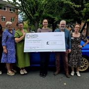 A North West Subaru owners’ club has handed over £1,000 to a charity supporting people living with dementia and their families.