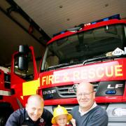 Sam Shaw with crew manager Pete Derbyshire and grandad Phil Speakman, at Darwen Fire Station