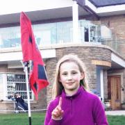 Emily James celebrates her hole in one