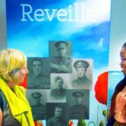 Project volunteer Kasongo Swana and library regular Isabel Butler discuss Reveille