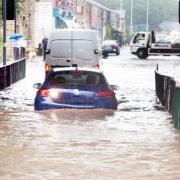 Vehicles negotiate the floods in Stubbins in 2012