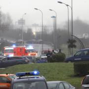 Police officers block the access to Dammartin-en-Goele, north east of Paris where the gunmen behind the Charlie Hebdo were traced