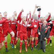 DELIGHT: Darwen’s players lift the play-off trophy having secured promotion to the North West Counties League Premier Division