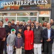 Abdul Ghaffar (back row fourth from left) of Sensi Fireplaces with Kate Hollern MP and local councillors outside the new business on Darwen St, Blackburn