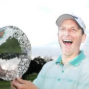 TRIUMPH: Michael Hunt celebrates with the Harold Ryden Trophy after a victory over Blackburn’s Anthony Harwood on his home course of Pleasington on Wednesday night