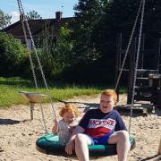 Leighton, eight, and Ruby Lancaster, three, playing on the team swing at  Glamorgan Grove Park in Gannow, Burnley
