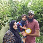 Shezmeen Munshi, Azaz Chanda and their son Mousa Chanda infront of the large trunk that almost crashed onto their car in East Park Road, Blackburn