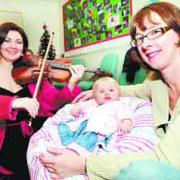 MINI MOZART FAN: Six-month-old Jessica Cullivan and her mum Jackie, of Worsthorne, get a rendition from Rachel Jones on her viola
