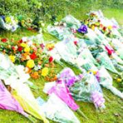 FLORAL TRIBUTES:  Bunches of flowers left at the scene of the car crash
