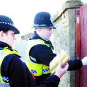 ACTION: PC Tracy Haigh and PC Chris Hammill attach the closure notice to the gate of the house in Hancock Street, Blackburn