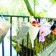 TRIBUTES: Flowers adorn the railings at Oueen’s Park, Blackburn, in memory of Mr Folkes