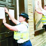 SHUT DOWN: PCSO Catherine Clough and PC John Fisher serve the closure order on the house in Reed Street, Burnle