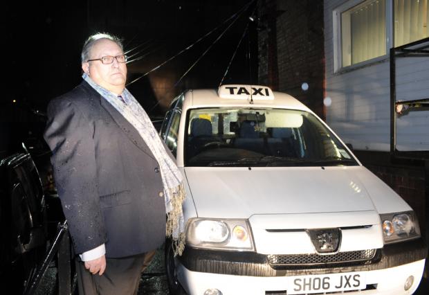 Lancashire Telegraph: Taxi driver Charlie Oakes and his white car