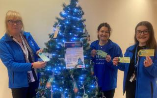Denise Gee, Demi Houghton, and Rebecca Bartle at the Give a Gift Christmas tree in Royal Blackburn Teaching Hospital