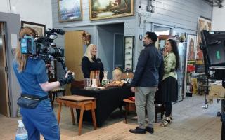 Sandra Lambert (middle) with Tez Ilyas, Roo Irvine  and BBC crews, filming Celebrity Antiques Road Trip