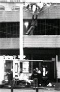 DRAMATIC MOMENT: A depressed man hangs over fencing on Blackburn market's car park