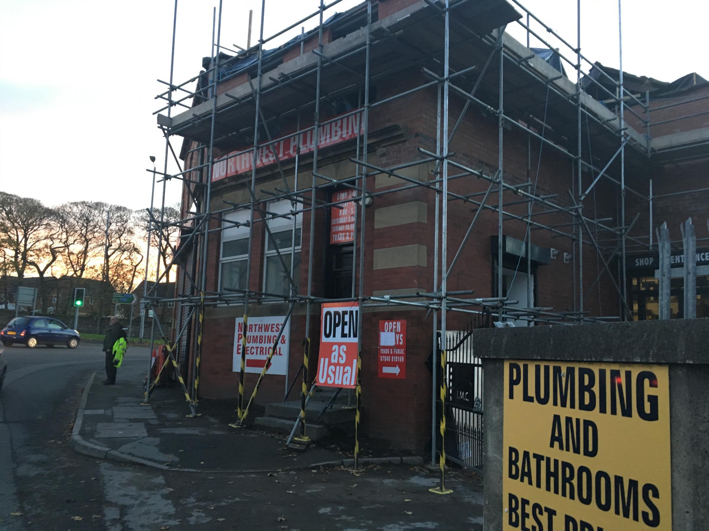 Partially collapsed building not fully repaired but business reopens